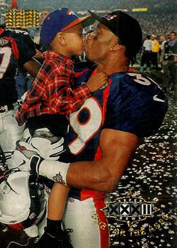 1998 SkyBox Premium #209 Ray Crockett kisses his son amid euphoric celebrations after game Front